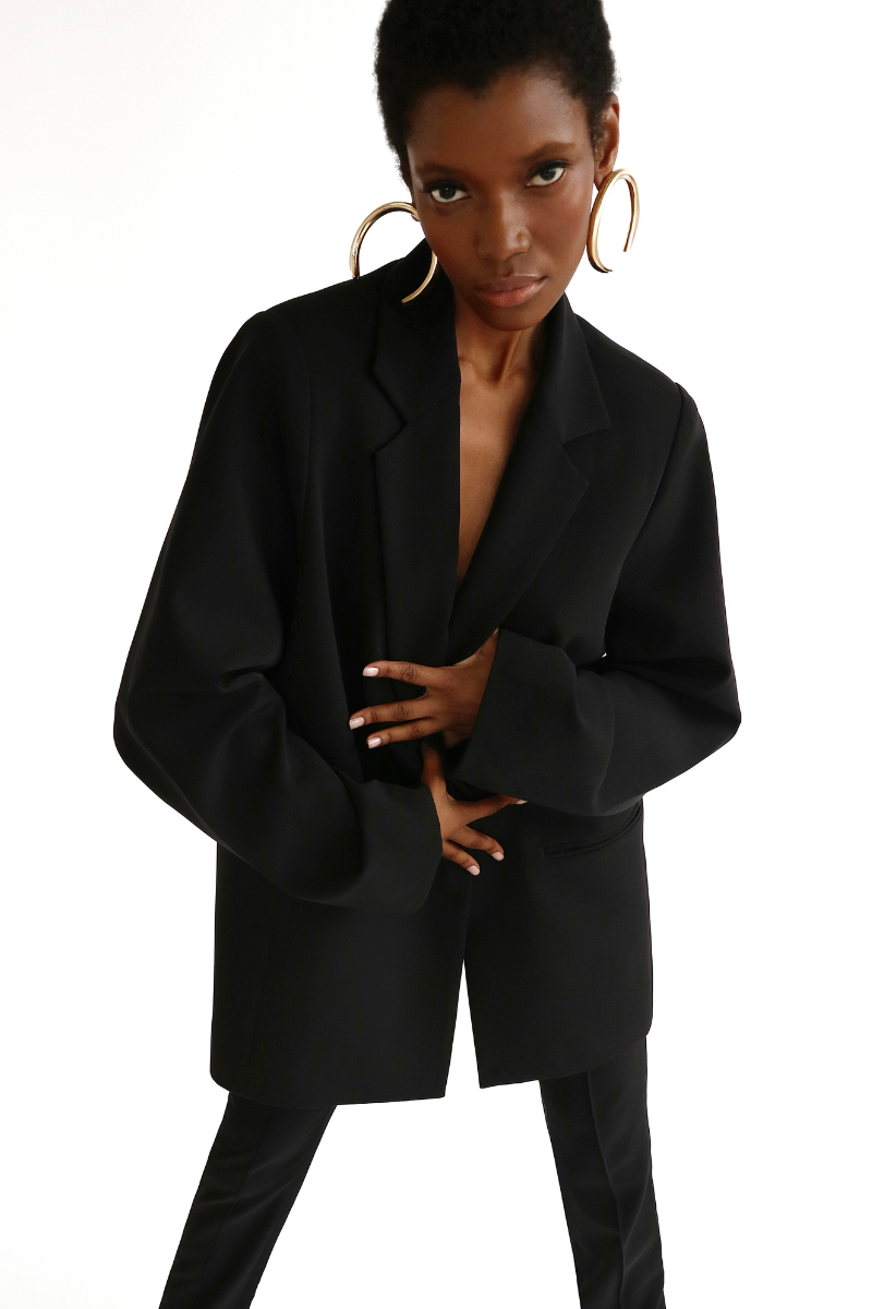 Model styled in TROUSER9 Fall 2024 black oversized blazer with matching pants for a complete look