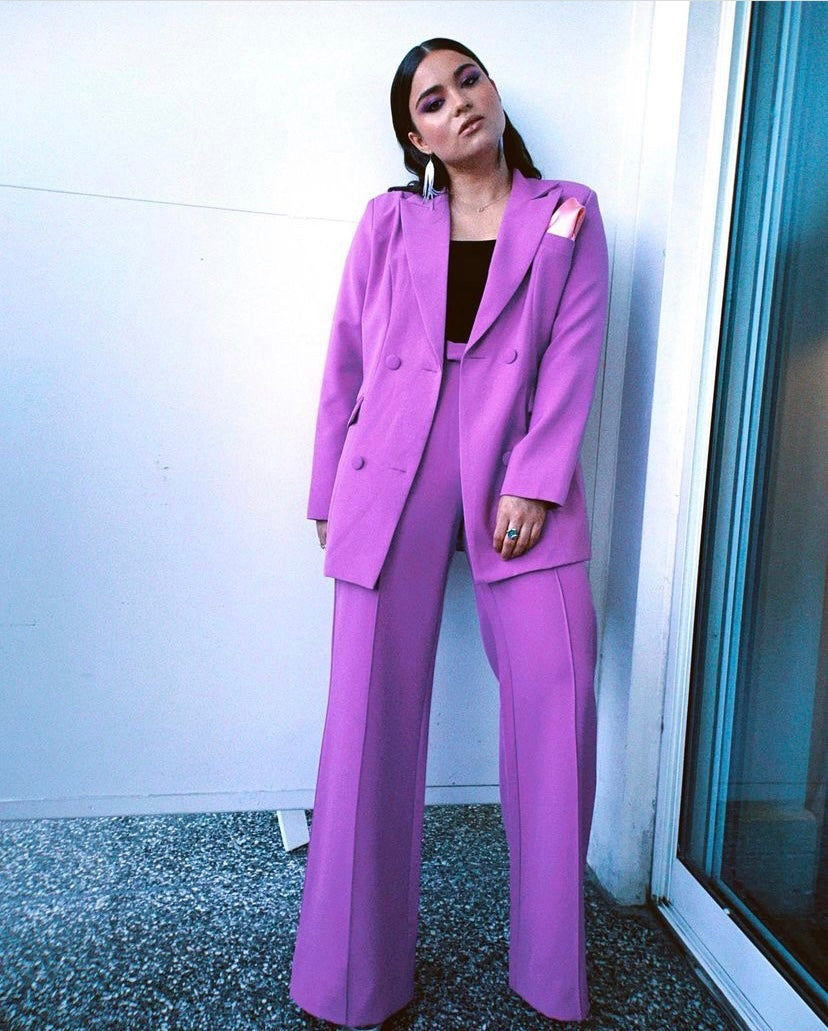 Devery Jacobs wearing the Trouser9 purple suit, featured in a celebrity style highlight on the homepage