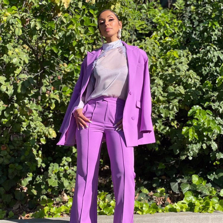 Mya wearing the Trouser9 purple suit, featured in a celebrity style highlight on the homepage