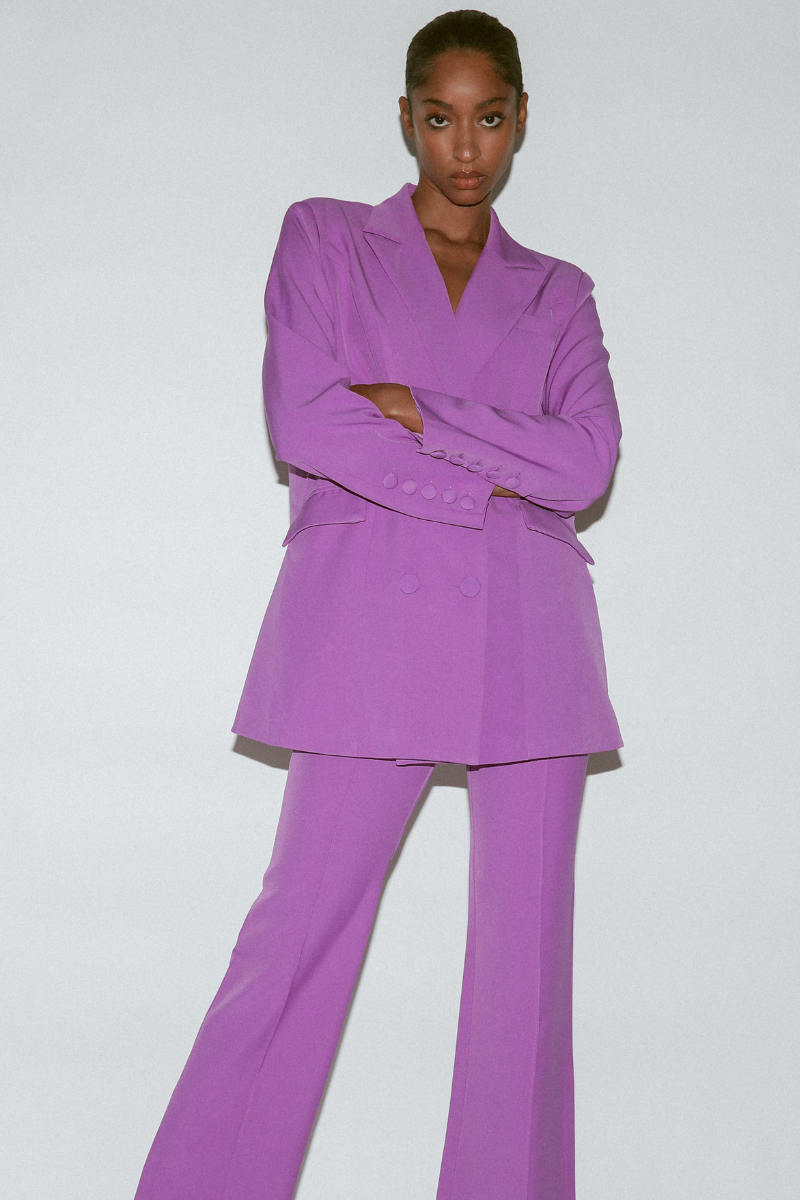 Front view of women's high-waisted purple wide leg pants with front pintucks shown with matching blazer