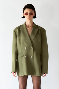 Front view of the women's green double-breasted blazer with a sophisticated design